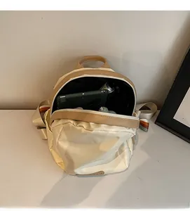 Top view showing the large interior capacity of the minimalist beige and brown backpack