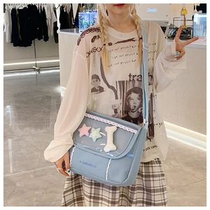 Detail of light blue ita bag featuring transparent PVC window and white lace trim