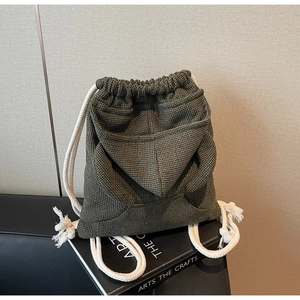 Close-up of olive green waffle texture fabric and creative drawstring pocket detail
