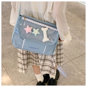 Detailed view of blue ita-bag with transparent PVC window and white lace trim