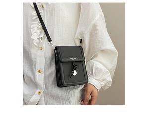 Detail of black woven PU leather mini crossbody bag with knot and silver magnetic clasp