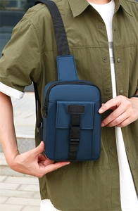 Detail of navy blue nylon crossbody chest bag with adjustable strap and sport buckle