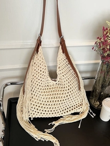 Bohemian crochet tote bag with long tassels and brown leather shoulder strap in cream