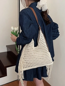 Large capacity woven tote bag with fringe details and leather strap for beach vacations