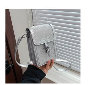 Close-up of a silver sequined small square crossbody phone bag with FANMEI & BAG logo