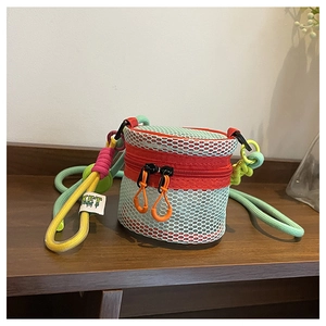 Detail of colorful hollow mesh mini crossbody bag with braided rope strap and zipper