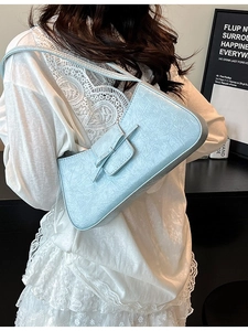 Light blue pleated baguette bag with bow decoration and slim shoulder strap