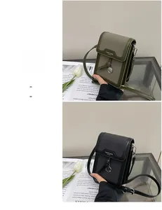 Detailed close-up of retro mini crossbody bag featuring leather and plaid fabric patchwork