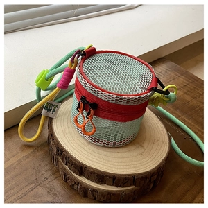 Detailed close-up of a mini hollowed-out crossbody bag on a natural wooden display