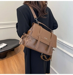 Brown soft leather tote bag with decorative side bows and wide strap for daily commute