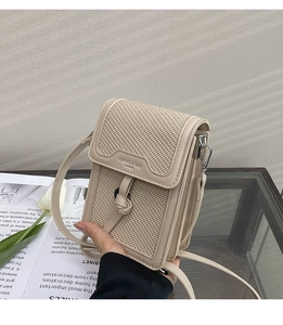 Detail of a beige woven mini crossbody bag showing a knotted leather strap and logo