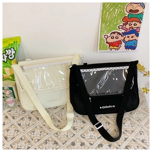 Detail showing white and black canvas Ita bags with transparent windows for pins