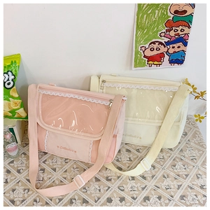 Detailed view of canvas messenger bags featuring a transparent PVC window and lace trim