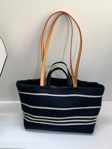 Large striped canvas tote bag in navy blue with leather handles for daily commute