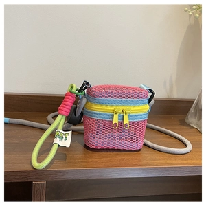 Detailed close-up of vibrant mesh crossbody bag with yellow zipper and KRT brand tag