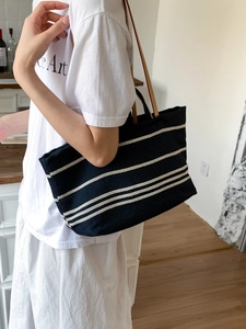 Striped canvas tote bag with black and white patterns and shoulder strap for women