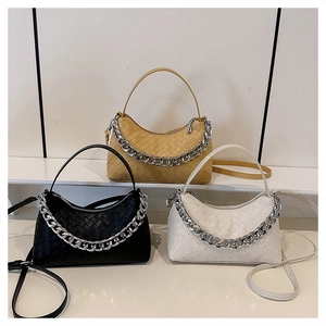 Detailed view of woven leather underarm bags in three colors with silver chain accents