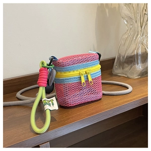 Detail of pink mesh mini bag with blue trim, yellow double zippers and neon green strap