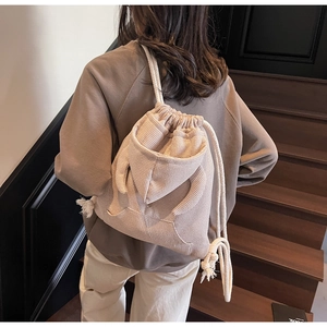 Detailed view of beige waffle fabric drawstring bag in creative hoodie style with cotton ropes