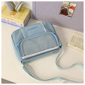 Detail of light blue messenger bag with white lace trim and Getlucky embroidery