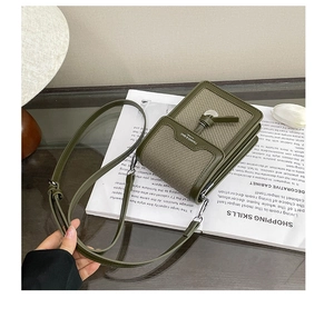 Detail of army green crossbody phone bag with woven fabric and round hardware on magazine