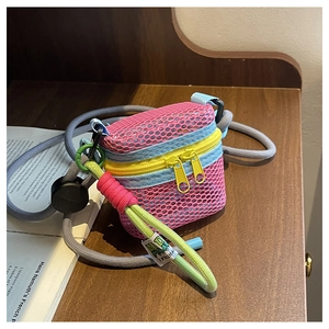 Detailed view of pink mesh mini crossbody bag with blue trim and yellow zippers