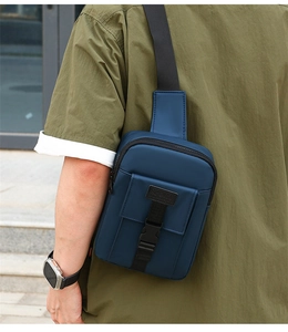 Detail of navy waterproof nylon crossbody bag with Sport label and buckle on dark strap