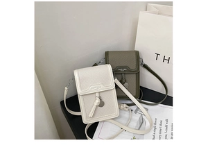Detailed view of cream and olive green textured square phone bags with metal pendants