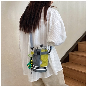 Detail of checkered drawstring bike water bottle bag with removable strap and floral charm