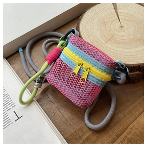 Detailed macro view of vibrant pink mesh mini bag with blue webbing and yellow zipper