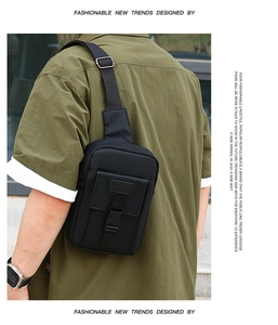 Detail of black sports crossbody bag featuring a front flap and durable buckle closure