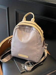 Minimalist lilac grey nylon backpack for women with adjustable straps and front pocket