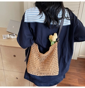 Detail of hand-woven hollow knit tote bag with premium brown leather strap