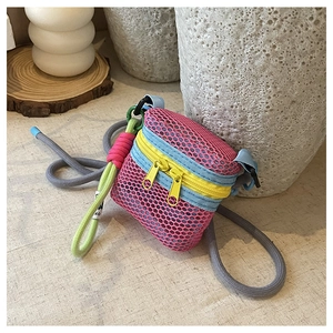 Close-up of a colorful mesh mini crossbody bag with vibrant neon honeycomb texture