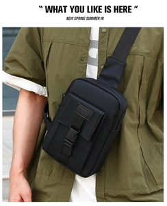 Detail of black sports crossbody bag featuring durable buckle and SPORT logo patch