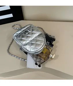 Internal view of silver quilted mini backpack showing capacity for phone and perfume