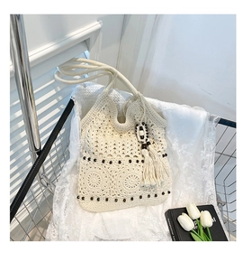 Detailed macro view of crochet cotton tote bag with beads and handmade tassel charm