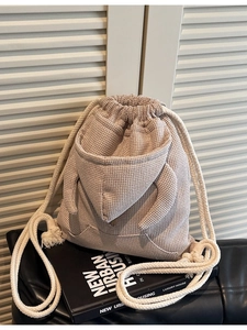 Beige waffle knit bucket bag featuring a creative hoodie-style kangaroo pocket and drawstring