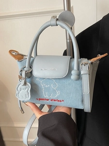 Denim dumpling bag with light blue leather trim and cartoon dog embroidery