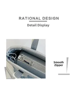 Detail of smooth silver zipper and fine litchi grain texture on the bucket bag