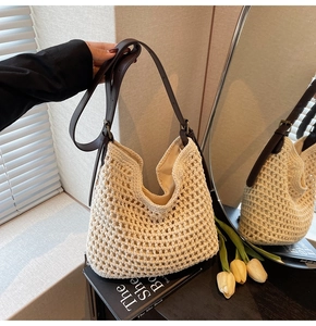 Detail of hand-woven cotton crochet tote bag with elegant brown leather shoulder strap