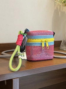 Mini nylon mesh crossbody bag with vibrant pink and blue patchwork and dual yellow zippers