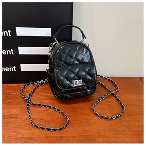 Detail of black quilted mini backpack with glossy PU leather and silver twist lock