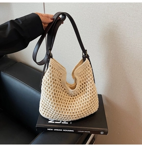 Detailed shot of beige crochet tote bag with adjustable brown leather shoulder straps