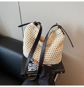 Detail of hand-woven beige cotton tote with adjustable dark brown leather strap