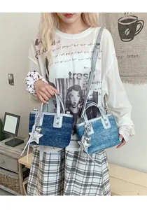 Detail view of denim bucket bags with silver rivets and metallic star heart charms