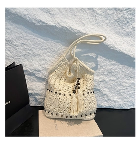 Close-up of handmade hollow crochet tote bag featuring wooden beads and tassel details