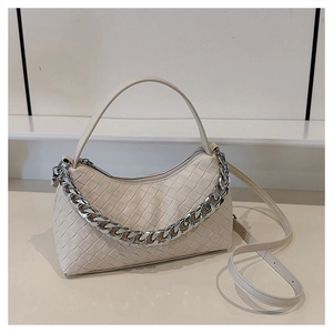 Close-up of cream woven hobo bag with chunky silver chain and adjustable strap