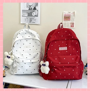 Detail of floral embroidery and brand label on large capacity canvas backpacks
