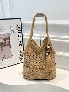 Handmade crochet tote bag in beige with black bead accents and bohemian fringe tassel
